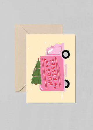 A cute post card with words “Hugs + Kisses (Fast and Free Delivery) ”. This greeting card is the perfect addition to any Christmas present. 