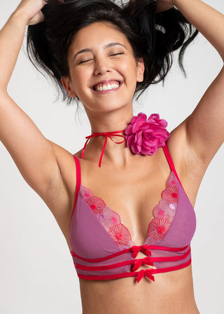 Happy woman confidently smiling in colorful bralette from Lioa Lingerie.