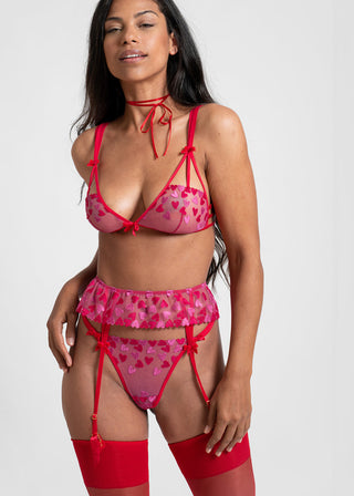 Woman looks confident in red and pink lingerie with heart deails from Lioa Lingerie