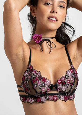 confident woman wears faux wire bra with black embroidery by lioa lingerie