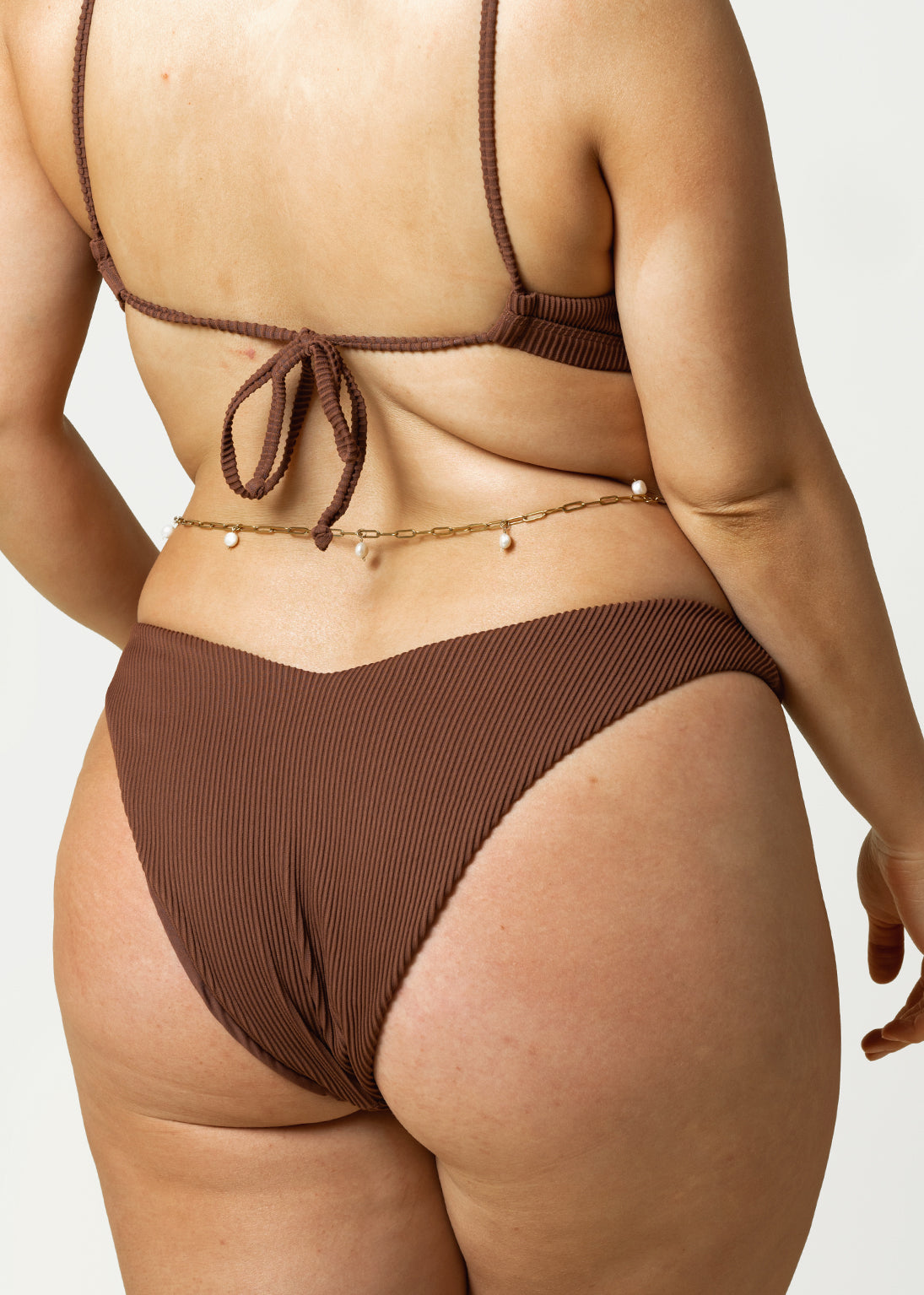 curby woman wears the cheeky bikini bottom in brown