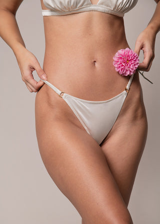 detail of the classic white satin thong from lioa lingier.e
