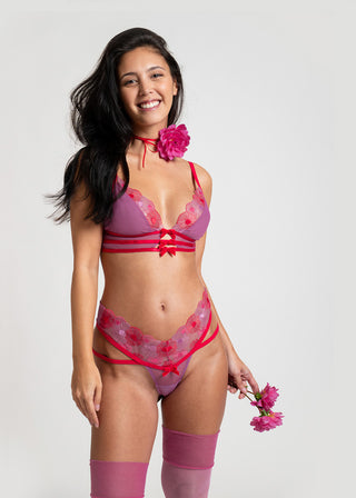 Happy woman in playful red and pink lingerie set from Lioa Lingerie.