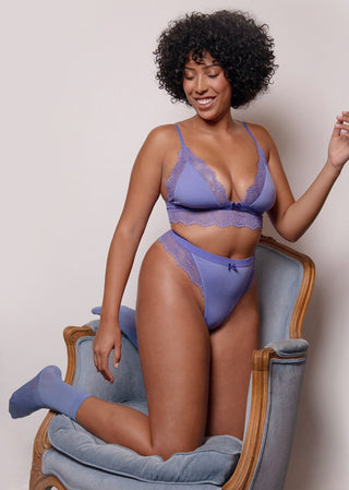 curvy woman looks happy in comfortable purple underwear from lioa lingerie.