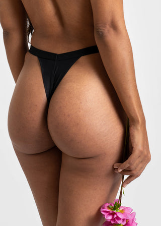 woman wears classic v shape thong in black by lioa lingerie