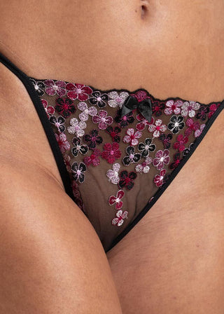 detail of the black embroidered thong with satin bow