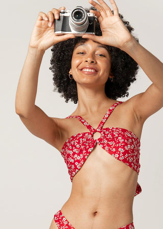 women takes a photo in her cute red wrap bikini top by lioa lingerie