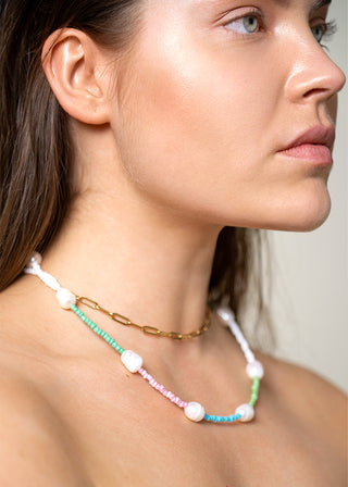 model wears the colorful bodychain as a necklace