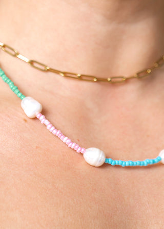 close detail of the colorful bodychain worn as a necklace.